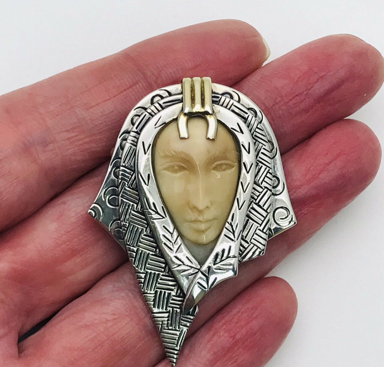 Zealandia Pendant Brooch, Woman wearing a head scarf, Sterling Silver and carved fossil tusk.