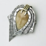Zealandia Pendant Brooch, Woman wearing a head scarf, Sterling Silver and carved fossil tusk.