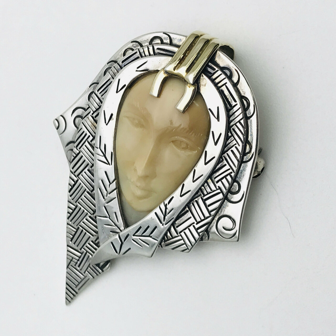 Zealandia Pendant Brooch, Woman wearing a head scarf, Sterling Silver and carved fossil tusk.