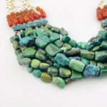 Vintage Tibetan silver necklace featuring turquoise, Coral, baroque pearls, and Carnelian