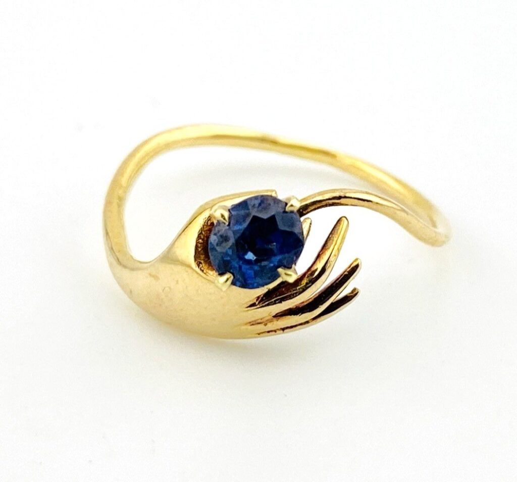 Hand Offering a Sapphire 14k Gold Ring