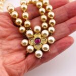 Renaissance style pearl necklace with garnet quatrefoil clasp