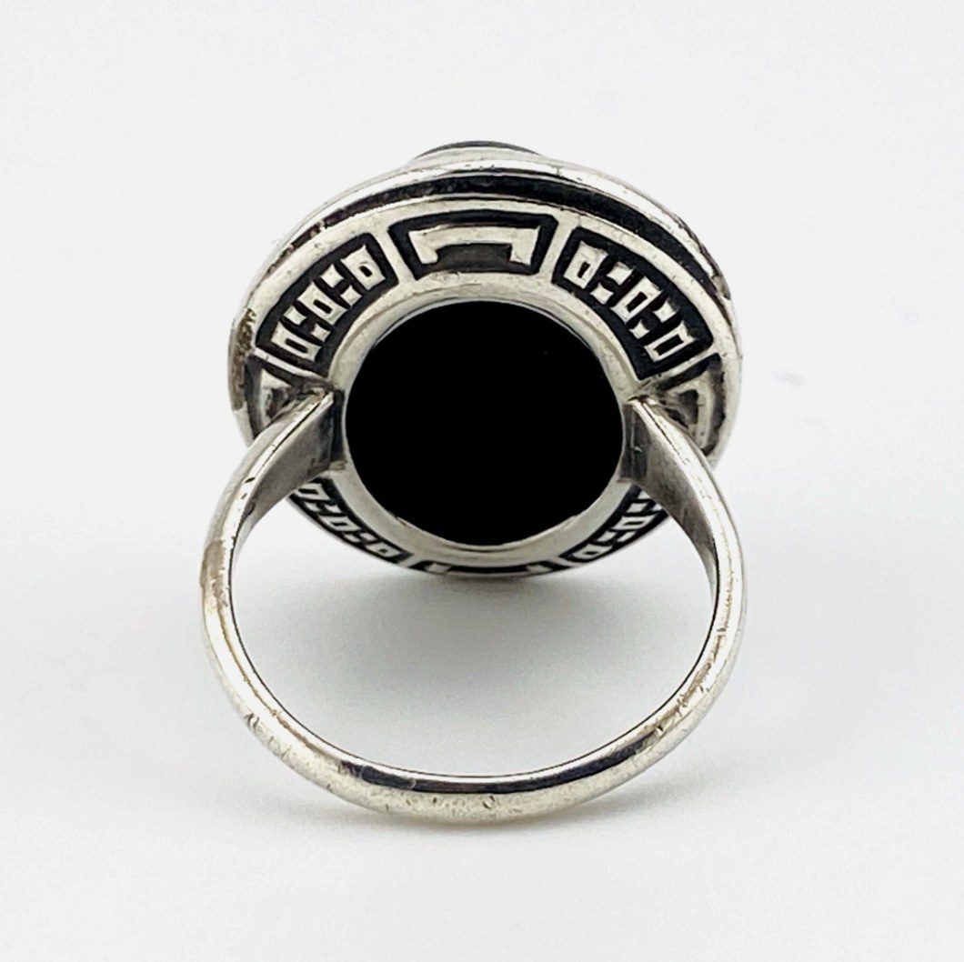 Vintage Uncas sterling silver ring with oval black onyx cabochon surrounded by marcasite stones in Art Deco design
