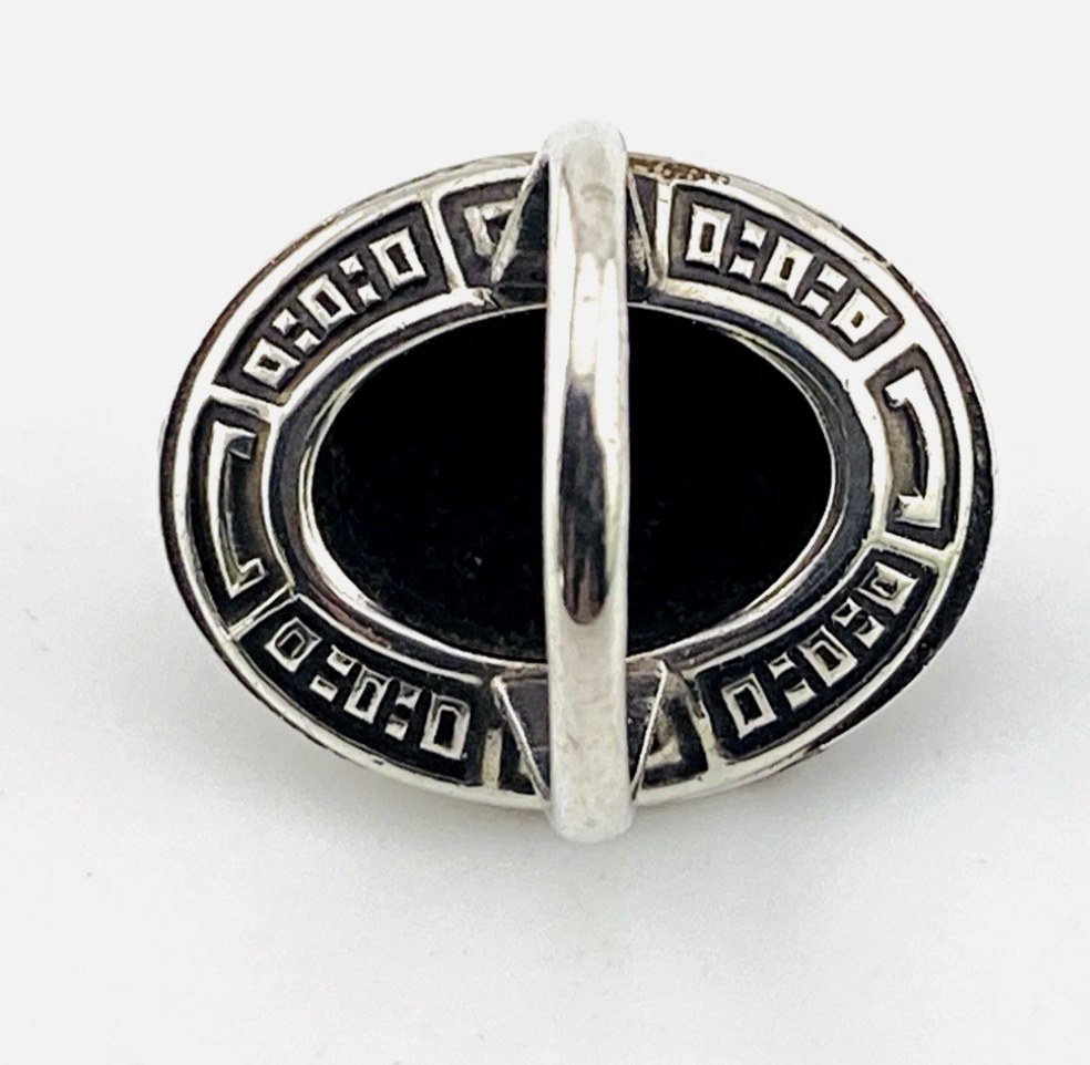Vintage Uncas sterling silver ring with oval black onyx cabochon surrounded by marcasite stones in Art Deco design