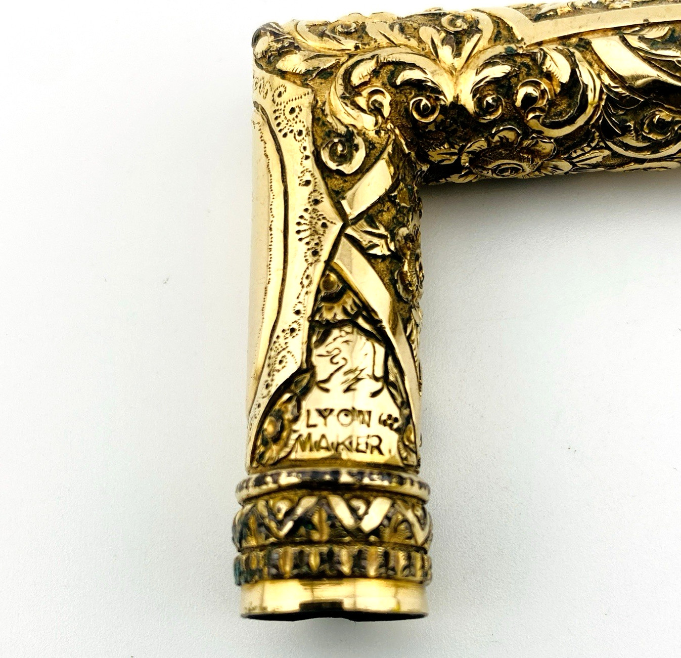 Hand engraved Lyon Maker hand engraved mark on antique cane handle.