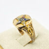 Side view of a vintage Eastern Star Masonic signet ring showing multicolor enamel star detail