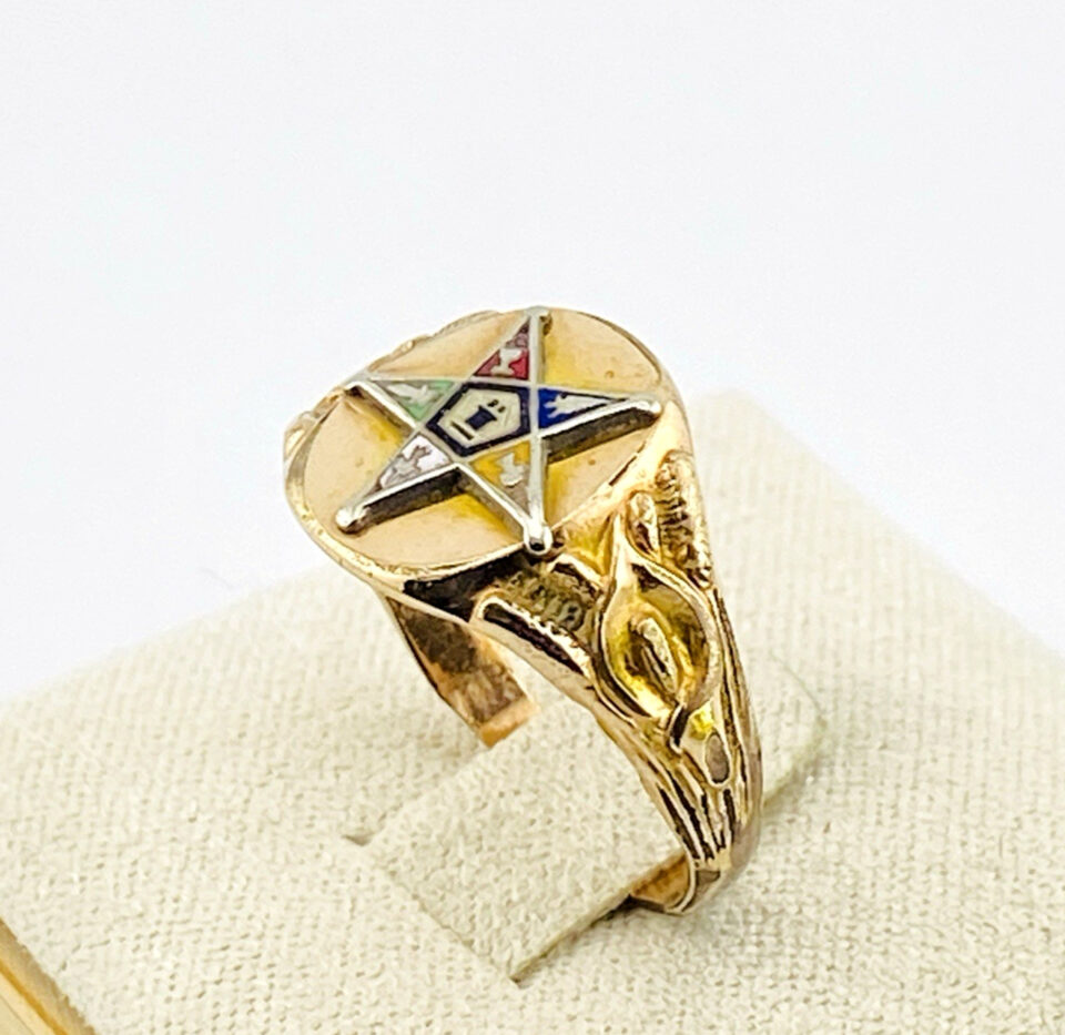 Side view of a vintage Eastern Star Masonic signet ring showing multicolor enamel star detail