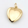 Zoom in of back of antique Victorian 10k gold puffy heart pendant showing smooth polished surface and engraved Lulu