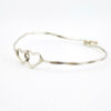 Hand wrought sterling silver cuff bracelet with hammered finish and interlocking double heart centerpiece