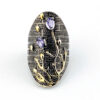Front of Black rhodium sterling silver statement ring with gold coral branch design and pear-shaped amethyst color stones in an elongated oval silhouette