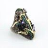 Black rhodium sterling silver statement ring with gold accents, green cubic zirconia, and pear-shaped amethyst stones in an elongated modernist design