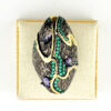 Black rhodium sterling silver statement ring with gold accents, green cubic zirconia, and pear-shaped amethyst stones in an elongated modernist design