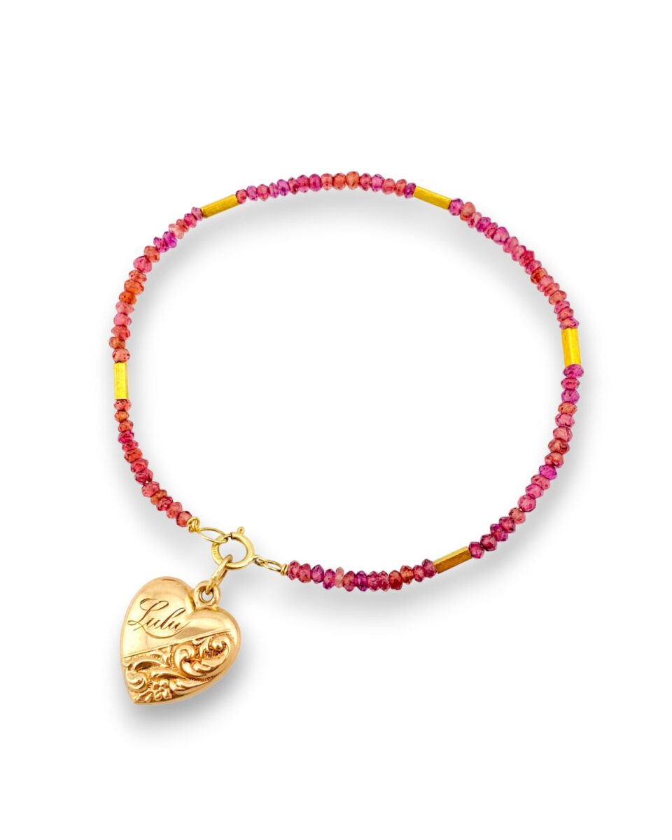 Rhodolite garnet and 14k gold bracelet styled with an antique Victorian gold puffy heart charm pendant for a layered look