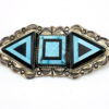 Sterling silver Southwestern brooch with geometric turquoise and black onyx inlay and stamped silver border