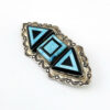 Sterling silver Southwestern brooch with geometric turquoise and black onyx inlay and stamped silver border