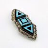 Sterling silver Southwestern brooch with geometric turquoise and black onyx inlay and stamped silver border