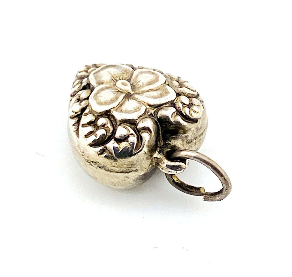 Victorian sterling silver puffy heart pendant with repoussé scrollwork, applied pansy flower, and engraved initials on the back.