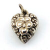 Victorian sterling silver puffy heart pendant with repoussé scrollwork, applied pansy flower, and engraved initials on the back.