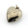 Victorian sterling silver puffy heart pendant with repoussé scrollwork, applied pansy flower, and engraved initials on the back.