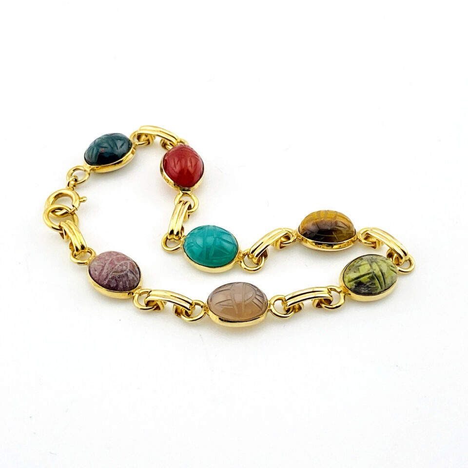 Vintage gold filled bracelet with seven carved scarab gemstones including carnelian, tiger eye, and bloodstone