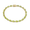 Vintage gold over sterling silver line bracelet with twenty oval faceted peridot gemstones arranged in a continuous row