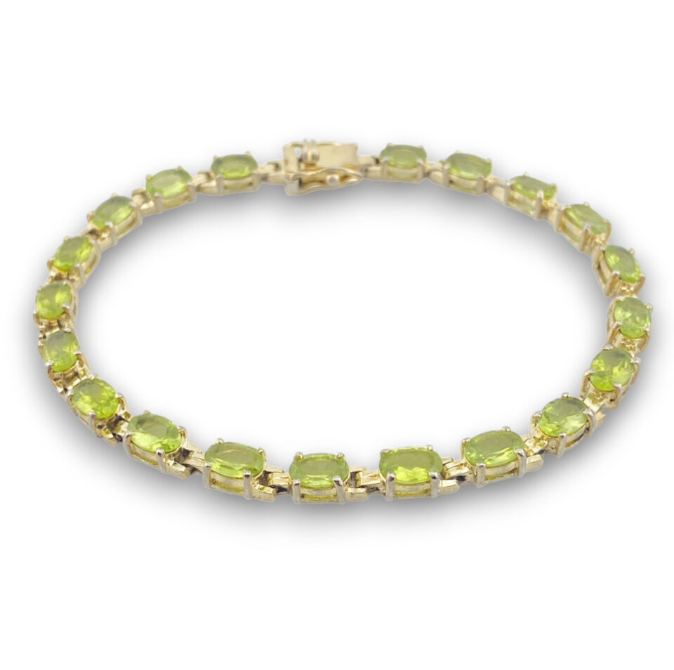Vintage gold over sterling silver line bracelet with twenty oval faceted peridot gemstones arranged in a continuous row