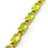 Vintage gold over sterling silver line bracelet with twenty oval faceted peridot gemstones arranged in a continuous row