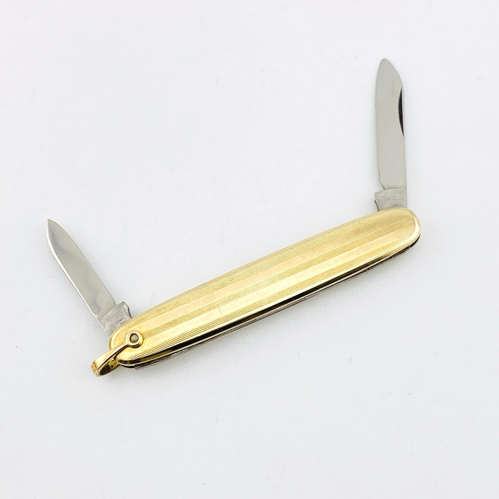Vintage Hayward gold filled elongated oval pocket knife with engraved pin-stripe texture, blank cartouche, stainless blades, and original box.