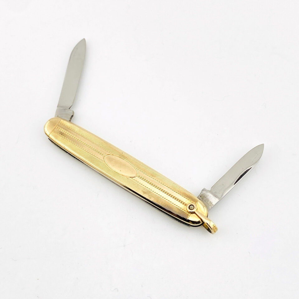 Vintage Hayward gold filled elongated oval pocket knife with engraved pin-stripe texture, blank cartouche, stainless blades, and original box.