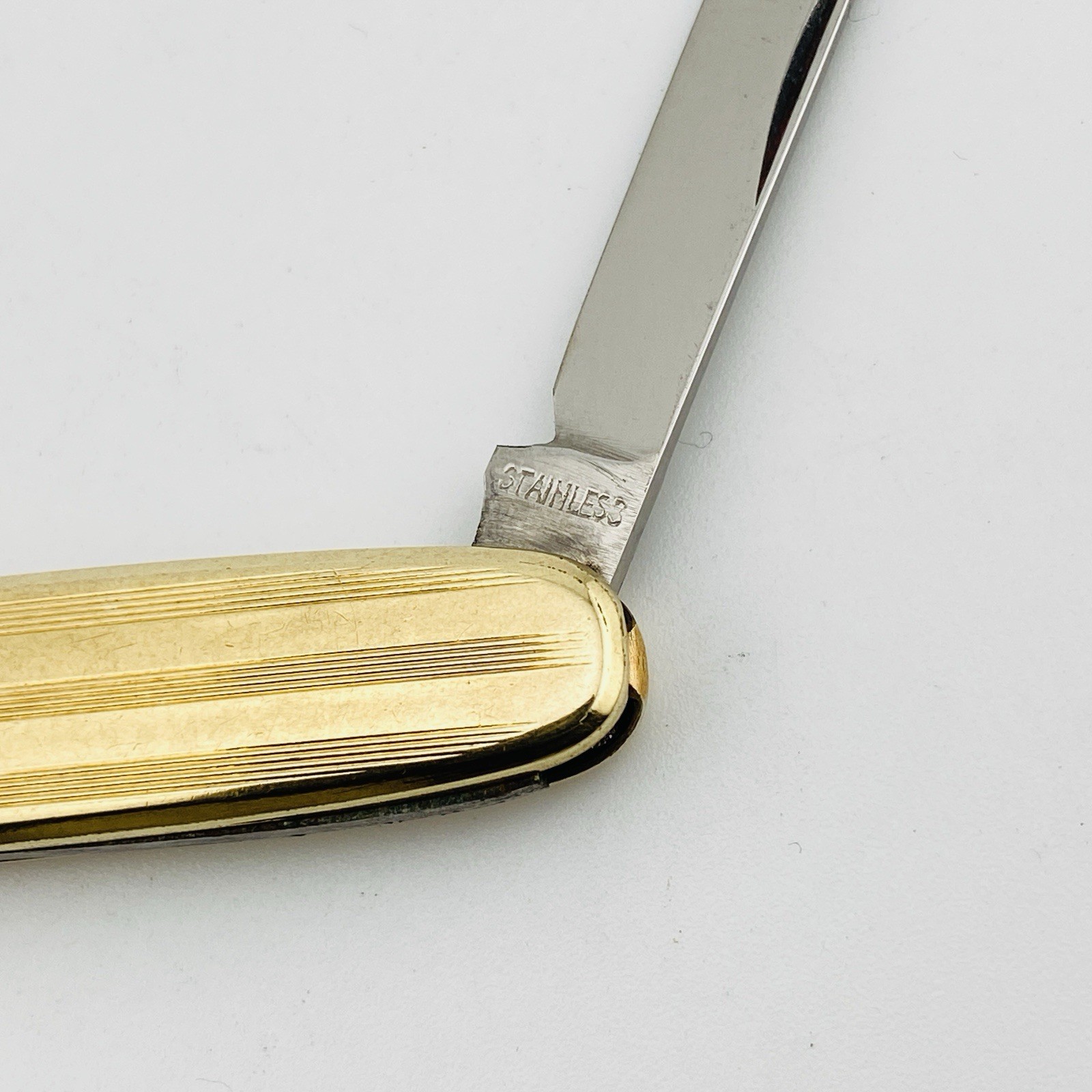 Vintage Hayward gold filled elongated oval pocket knife with engraved pin-stripe texture, blank cartouche, stainless blades, and original box.