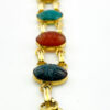Close up of vintage 12k gold filled double row scarab bracelet with seven carved stone scarabs