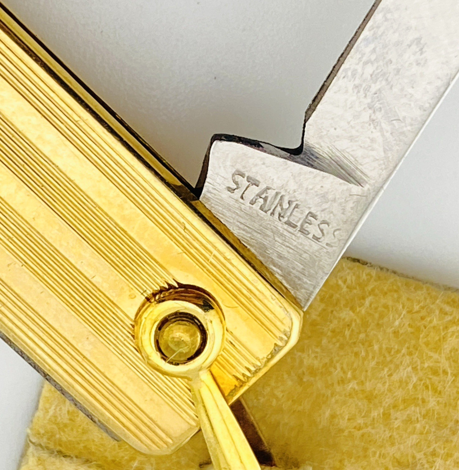 Vintage Simmons gold filled rectangular pocket knife with engraved pin-stripe texture, maker-stamped swivel ring, stainless blades, and original box.