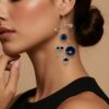 Modernist geometric dangle earrings in gold filled wire with black glass beads sculptural design on a model for illustration