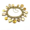 Vintage gold filled charm bracelet with fifteen locket charms including hearts book and enamel designs