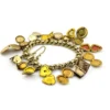 Vintage gold filled charm bracelet with fifteen locket charms including hearts book and enamel designs