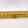 Vintage Speidel Golden Chord watch band box with textured beige plastic and gold accents from the 1950s