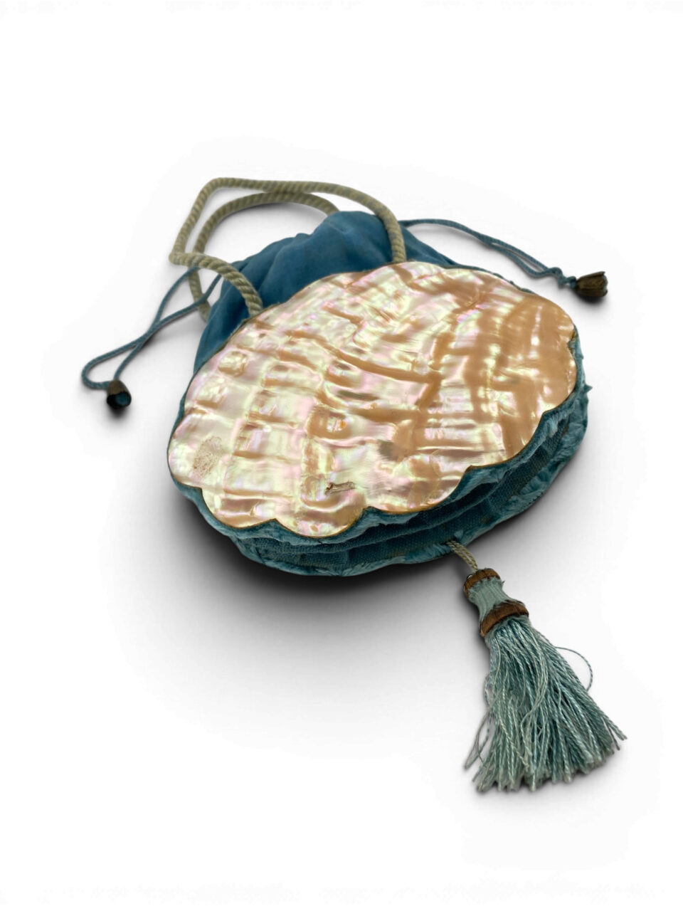 Antique Art Nouveau era mother-of-pearl and blue silk necessaire purse with scalloped shell panels, rope handles, and tassel.