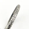 Antique P&H sterling silver bangle bracelet with carved scrolls, vines, leaves, and forget-me-not flowers.