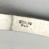 Antique P&H sterling silver bangle bracelet with carved scrolls, vines, leaves, and forget-me-not flowers.