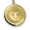 Antique Hayward 1/20 12K gold filled round photo locket with chased shield cover, floral garland, pinstripe back, and interior photo frames
