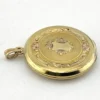 Antique Hayward 1/20 12K gold filled round photo locket with chased shield cover, floral garland, pinstripe back, and interior photo frames