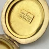Antique Hayward 1/20 12K gold filled round photo locket with chased shield cover, floral garland, pinstripe back, and interior photo frames