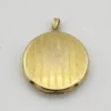 Antique Hayward 1/20 12K gold filled round photo locket with chased shield cover, floral garland, pinstripe back, and interior photo frames