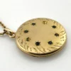 Antique Victorian gold filled round locket necklace with paste stone edging, bloomed gold finish, engraved EM monogram, and 21 inch chain