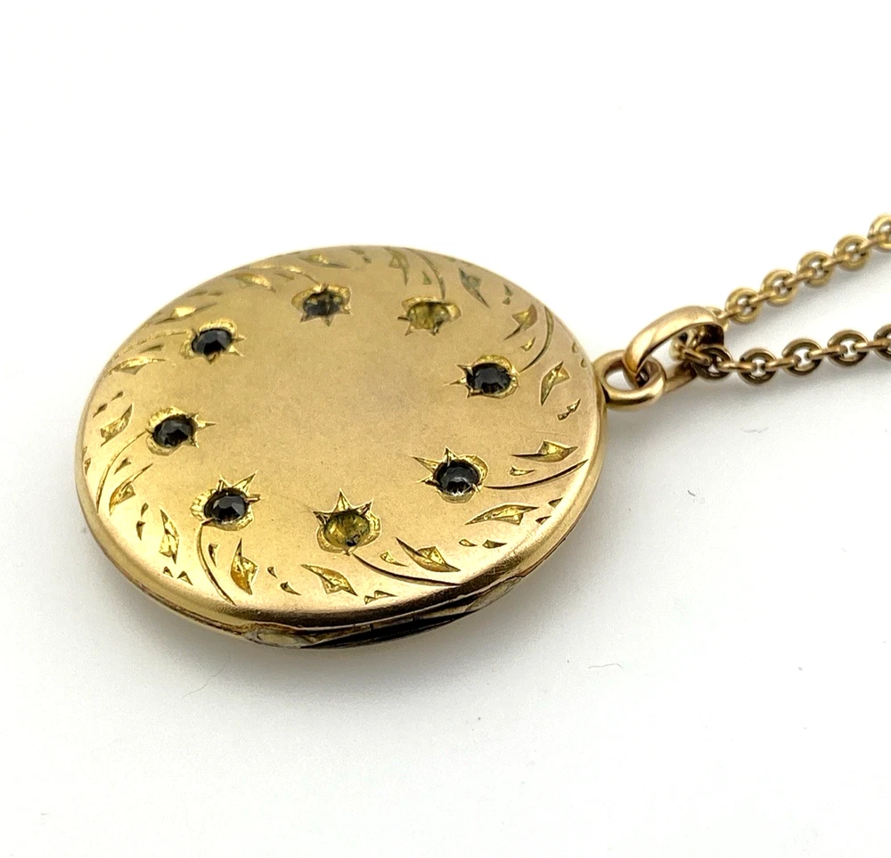 Antique Victorian gold filled round locket necklace with paste stone edging, bloomed gold finish, engraved EM monogram, and 21 inch chain