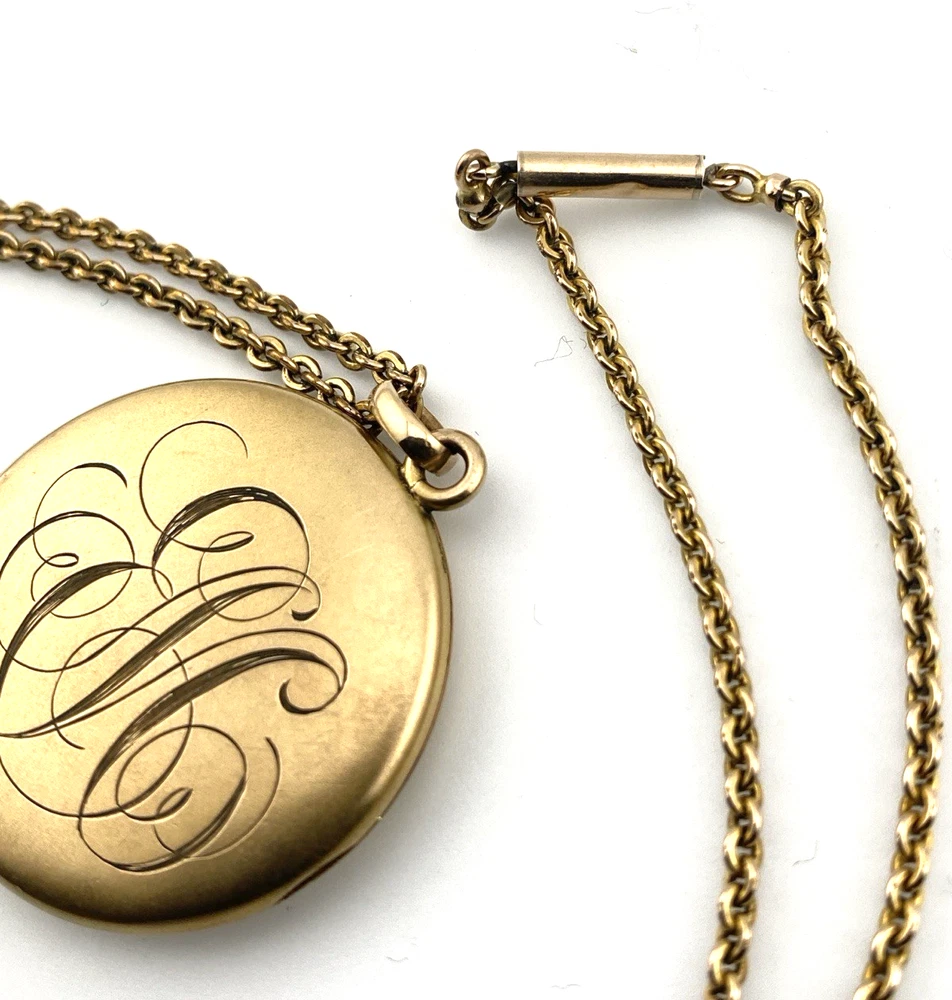 Antique Victorian gold filled round locket necklace with paste stone edging, bloomed gold finish, engraved EM monogram, and 21 inch chain