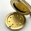 Antique Victorian gold filled round locket necklace with paste stone edging, bloomed gold finish, engraved EM monogram, and 21 inch chain