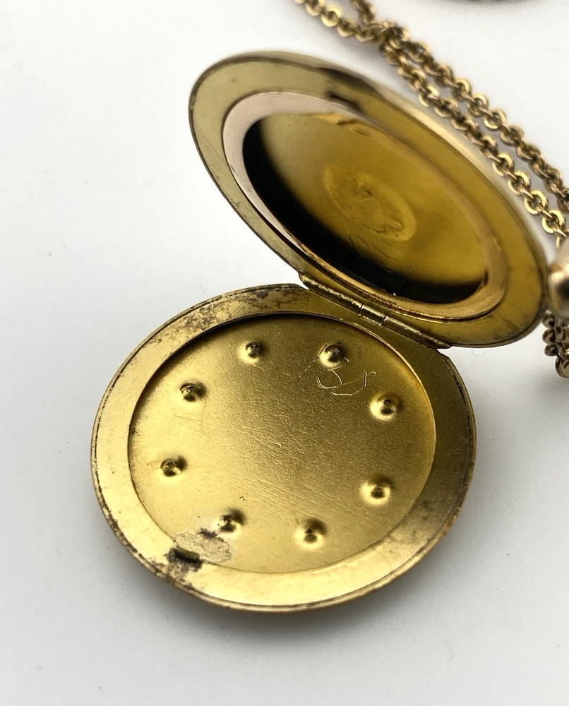 Antique Victorian gold filled round locket necklace with paste stone edging, bloomed gold finish, engraved EM monogram, and 21 inch chain