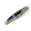 Art Deco JHP sterling silver child’s size bangle bracelet with champlevé enamel blue flower center and geometric textured band