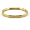 Ballou child’s size 1/20 12K gold filled hinged bangle bracelet with engraved parallel line texture and raised scrolled center